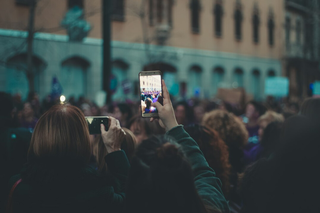 people using smartphones in crowd