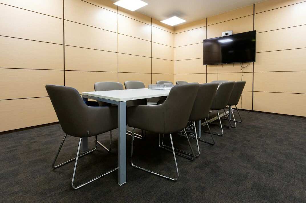 Minimalist meeting room of a research institute with wooden table