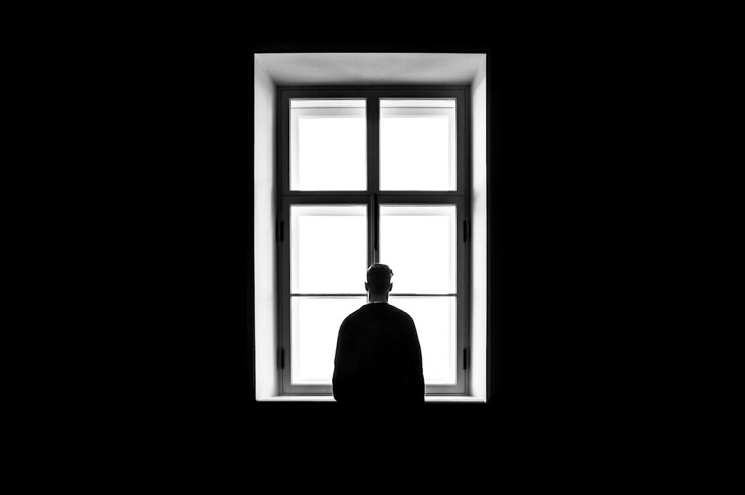 person reflecting by window